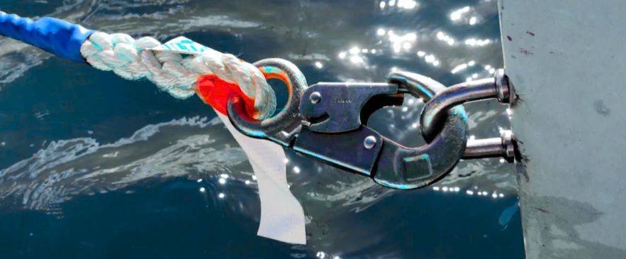 safety drills for sailors, Close-up of sailboat mooring clip and rope during docking safety drills for sailors
