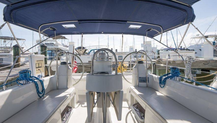 Why Every Sailor Should Learn Sailboat Rigging Basics. Cockpit view of sailboat rigging and lines at the marina — sailboat rigging guide setup for beginners learning how to rig a sailboat.