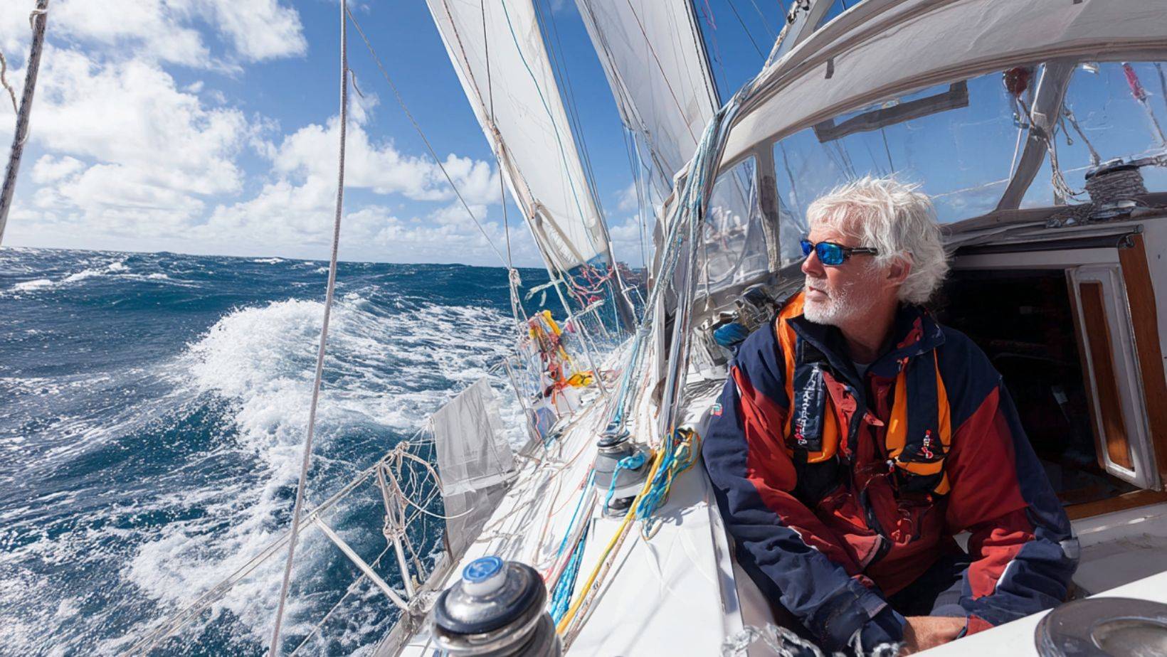 Why Every Sailor Should Learn Sailboat Rigging Basics/ Sailor observing sailboat rigging while sailing offshore — sailboat rigging guide for beginners learning how to rig a sailboat.